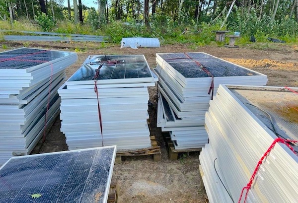 damaged solar panels stacked